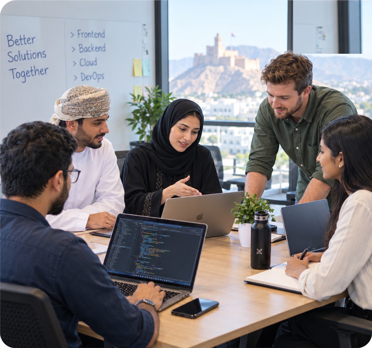 A technology team collaborating around a laptop during a project planning session